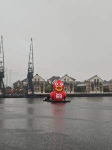 Giant Inflatable Duck Replica with Foodhub Branding on London Docks